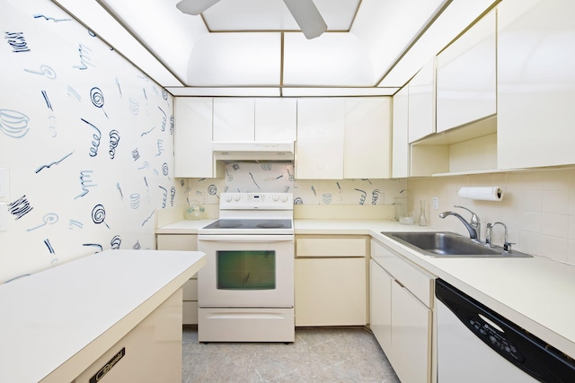 kitchen with white cabinetry, white appliances, and sink