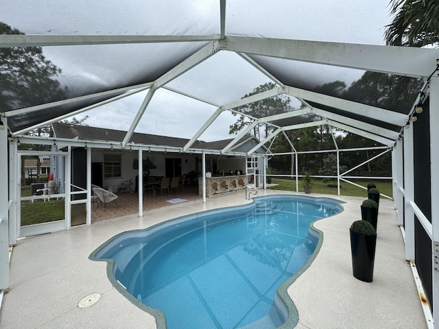 view of swimming pool with a lanai and a patio