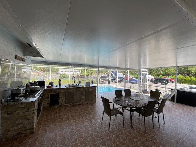 sunroom with a healthy amount of sunlight and sink