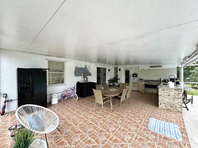 view of patio / terrace with an outdoor kitchen and an outdoor wet bar