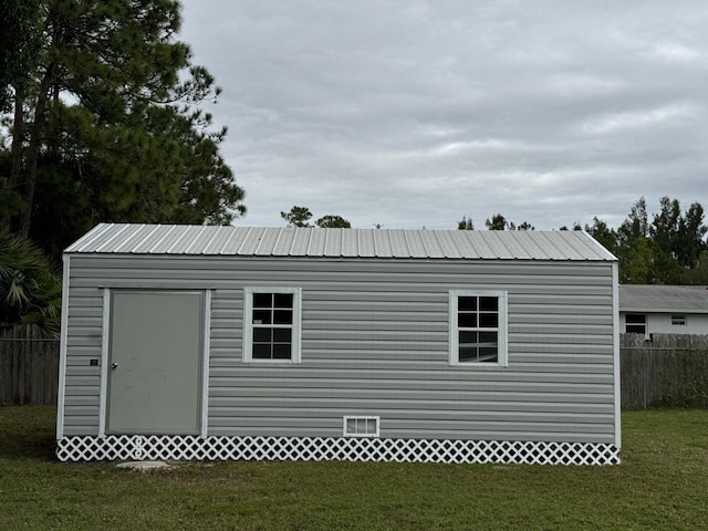 view of outbuilding featuring a lawn