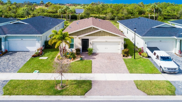 view of front of property with a front yard and a garage