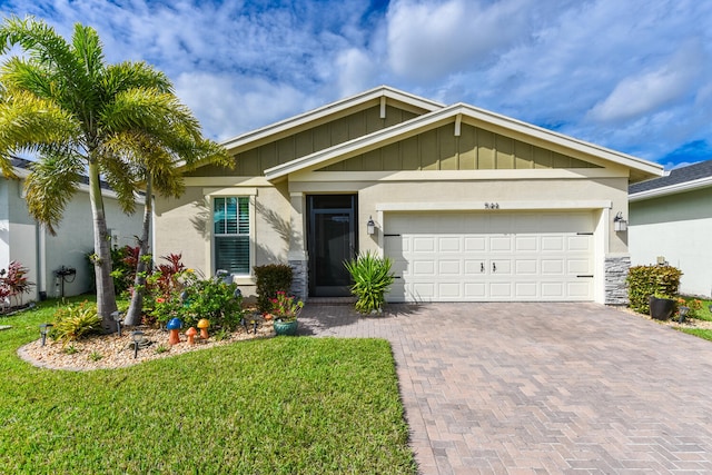 view of front of house with a garage and a front lawn