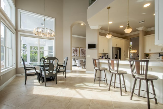 kitchen featuring decorative light fixtures, white cabinets, high end fridge, and a chandelier