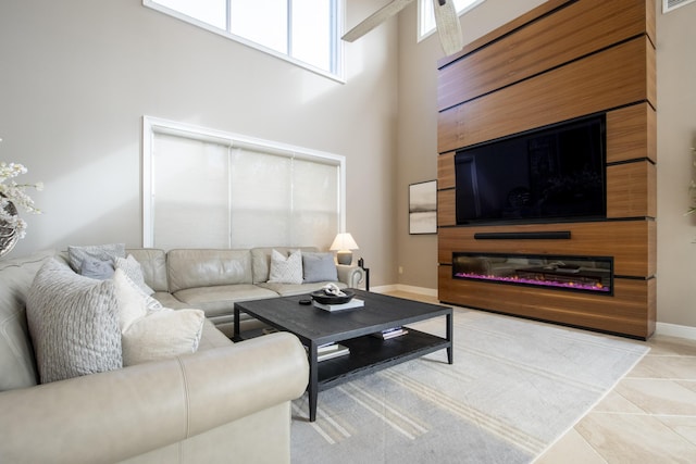 living room featuring a towering ceiling and tile patterned floors