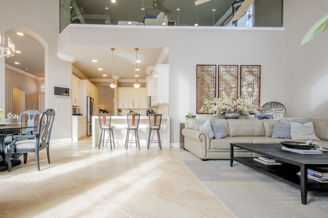 living room featuring a high ceiling and crown molding