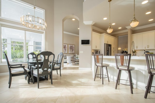 kitchen with high end fridge, white cabinetry, and pendant lighting