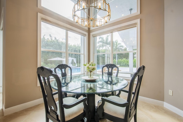 dining space with light tile patterned flooring and an inviting chandelier