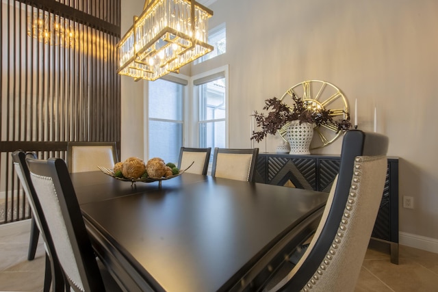 tiled dining space with a chandelier