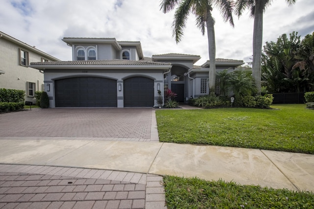 mediterranean / spanish-style house with a front lawn and a garage