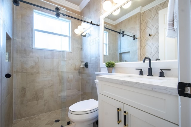 bathroom featuring toilet, vanity, ornamental molding, and a shower with shower door