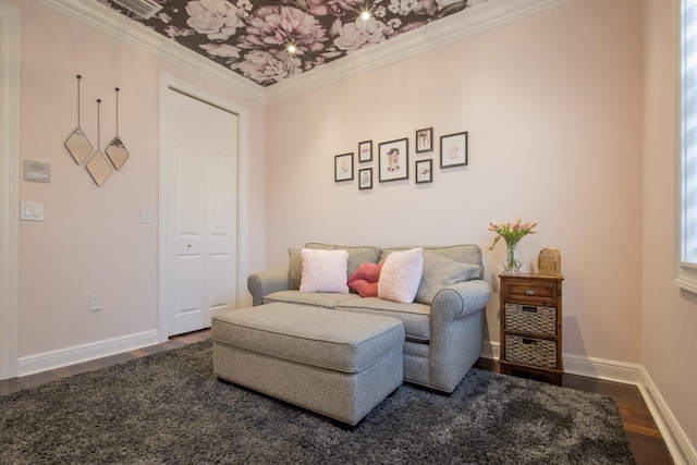 living area with hardwood / wood-style floors and ornamental molding