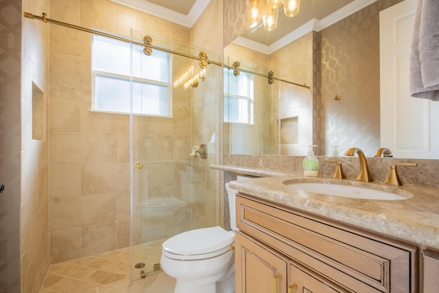 bathroom with toilet, ornamental molding, walk in shower, and vanity