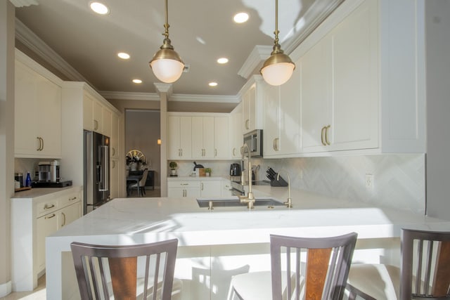 kitchen with light stone counters, decorative light fixtures, stainless steel appliances, tasteful backsplash, and a kitchen bar