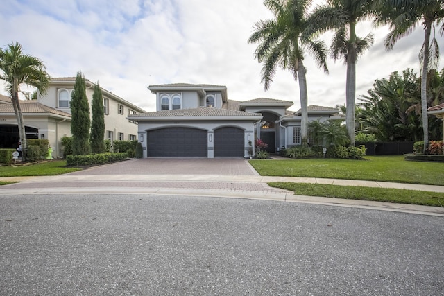 view of front of property featuring a front yard and a garage