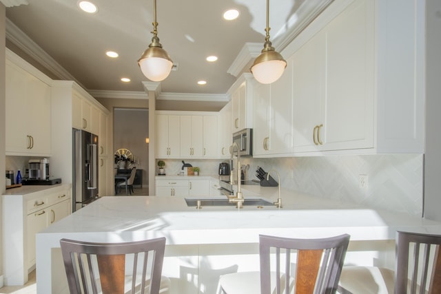 kitchen with stainless steel appliances, a kitchen bar, decorative backsplash, and hanging light fixtures