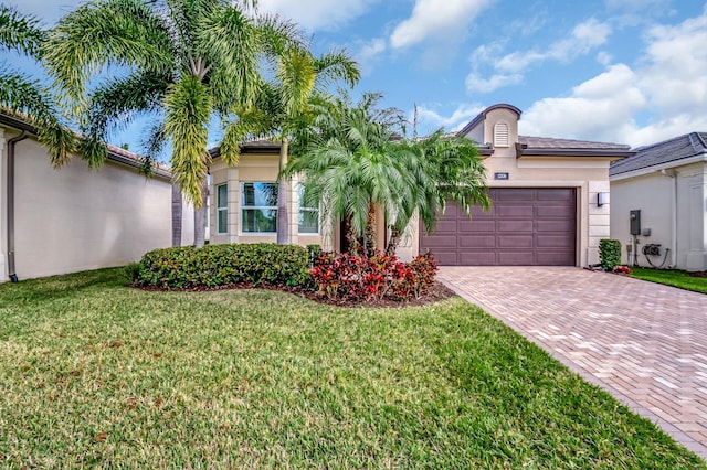 mediterranean / spanish-style home with a front yard and a garage