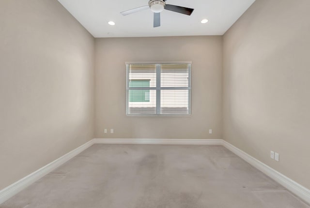 carpeted spare room featuring ceiling fan