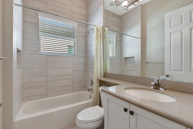 full bathroom with vanity, shower / tub combo, and toilet