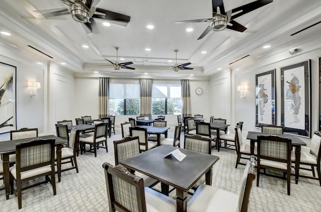 dining room with light colored carpet and ceiling fan