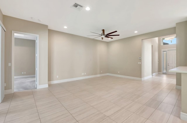 empty room with light tile patterned floors and ceiling fan