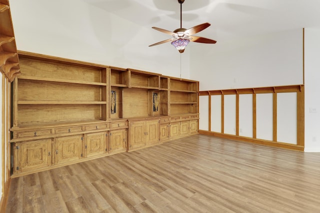 unfurnished living room featuring ceiling fan and light hardwood / wood-style flooring