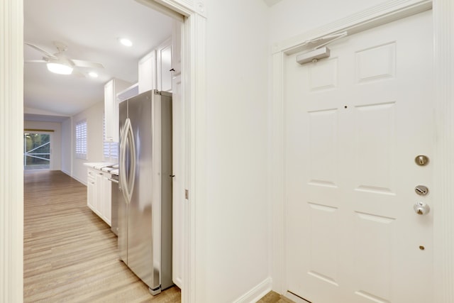 kitchen with ceiling fan, light hardwood / wood-style floors, white cabinetry, and stainless steel appliances