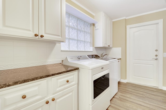 laundry area with crown molding, cabinets, separate washer and dryer, and light wood-type flooring