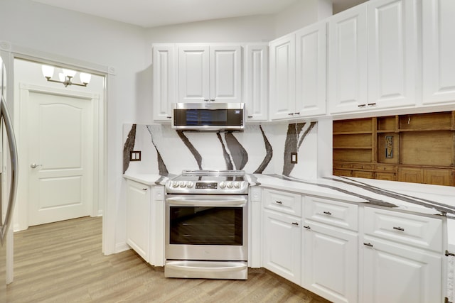 kitchen featuring a chandelier, white cabinetry, light hardwood / wood-style floors, and appliances with stainless steel finishes