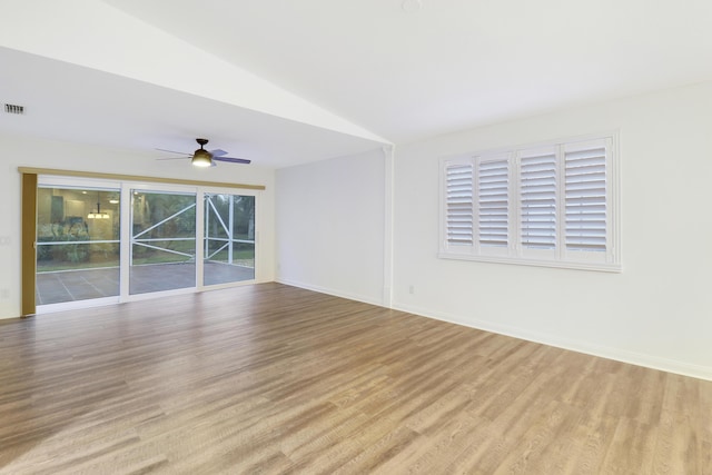 empty room with ceiling fan, light hardwood / wood-style floors, and lofted ceiling