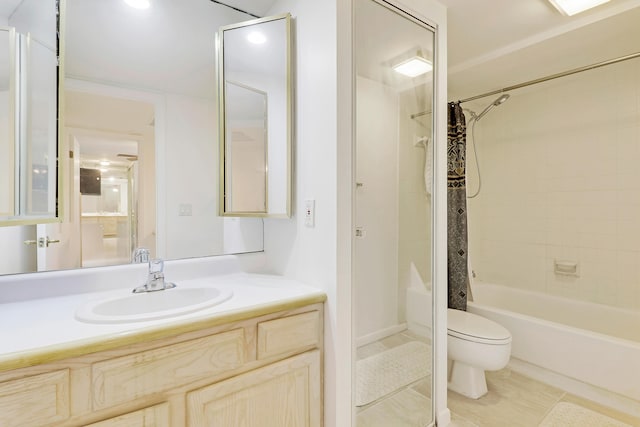 full bathroom featuring tile patterned floors, shower / bath combo with shower curtain, vanity, and toilet