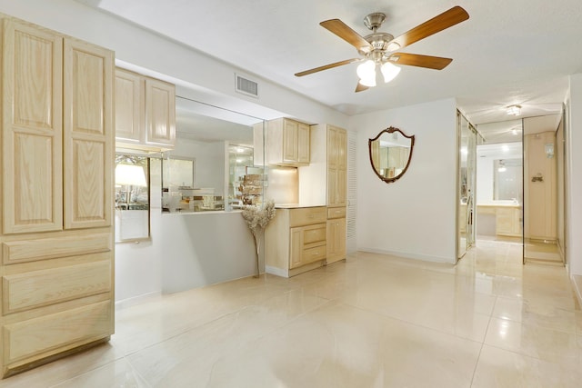 kitchen featuring light brown cabinetry, ceiling fan, and light tile patterned flooring