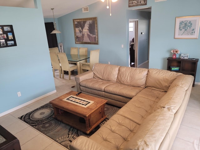 tiled living room featuring vaulted ceiling