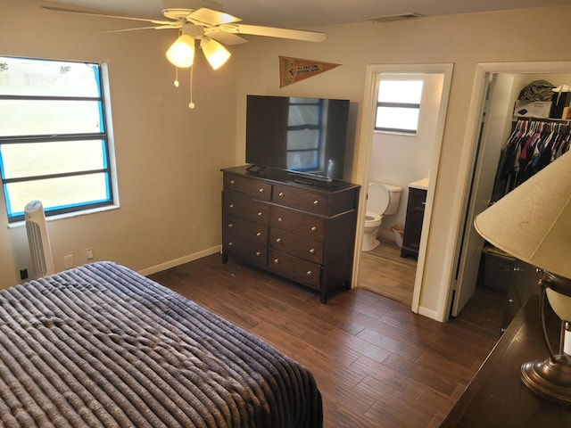 bedroom featuring a closet, ceiling fan, ensuite bathroom, and dark wood-type flooring