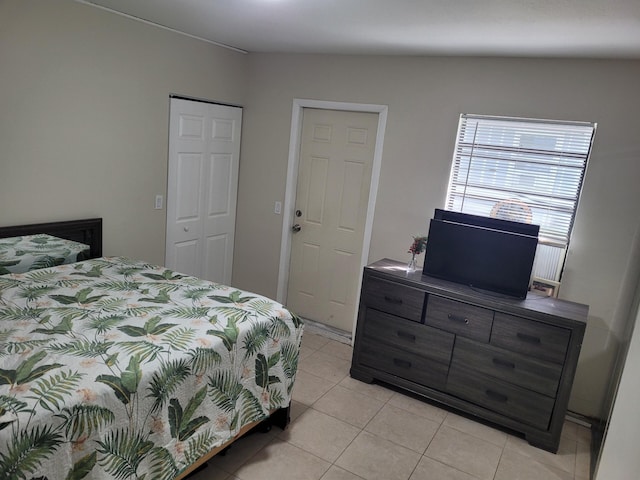 bedroom with a closet and light tile patterned floors