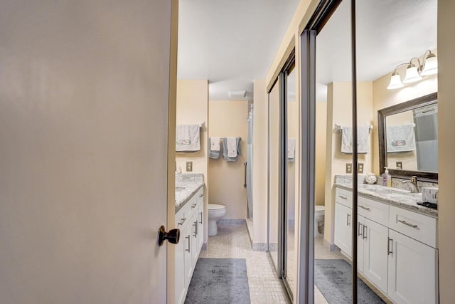 full bathroom with toilet, tile patterned flooring, and vanity