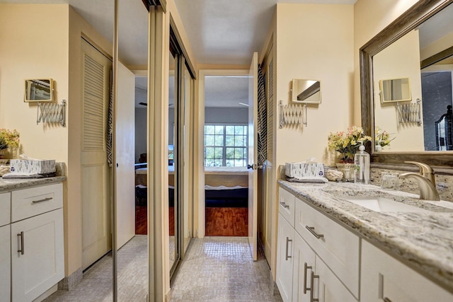 full bathroom featuring vanity, an AC wall unit, and ensuite bathroom