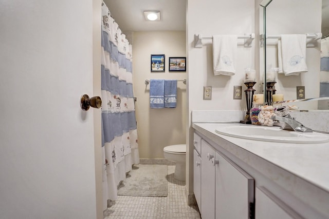 bathroom with a shower with shower curtain, toilet, vanity, baseboards, and tile patterned floors