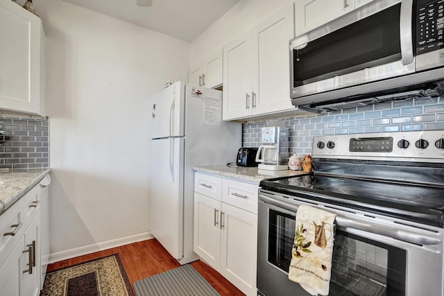 250 NE 20th St Unit 3070, Boca Raton, FL 33431 - kitchen with stainless steel appliances, visible vents, white cabinetry, and light wood-style flooring