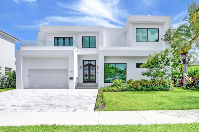 contemporary house featuring french doors and a front yard