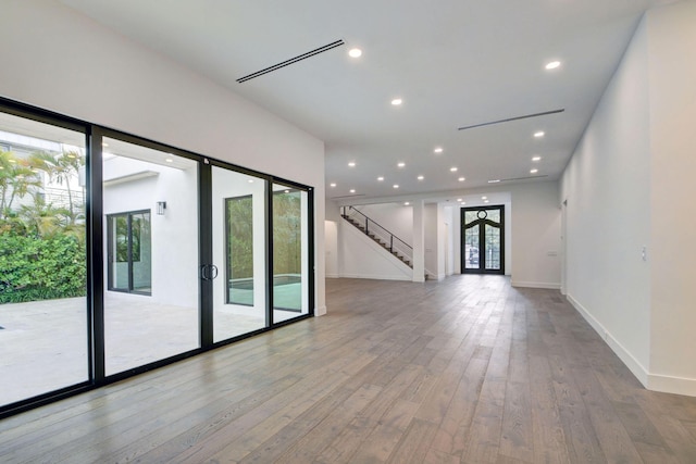 empty room featuring light hardwood / wood-style floors and french doors