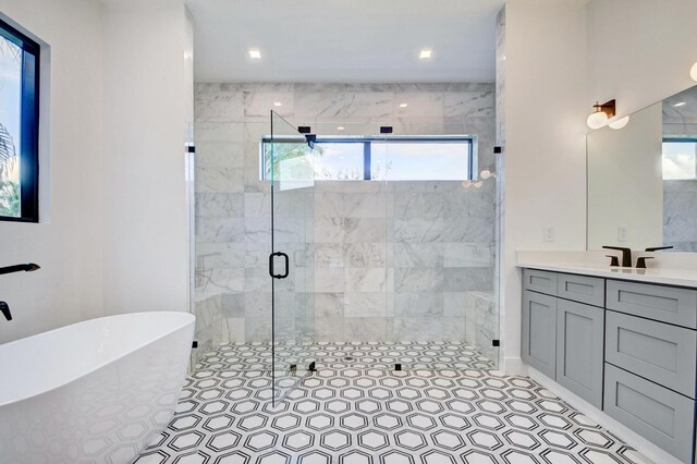 bathroom featuring an enclosed shower, vanity, and a wealth of natural light