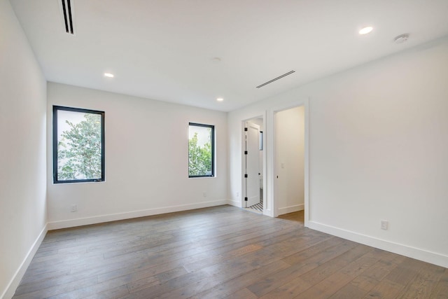 spare room featuring dark hardwood / wood-style flooring