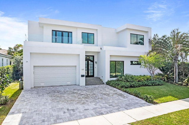 contemporary home featuring a garage and a balcony