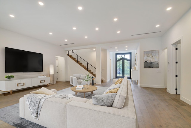 living room featuring light hardwood / wood-style floors and french doors