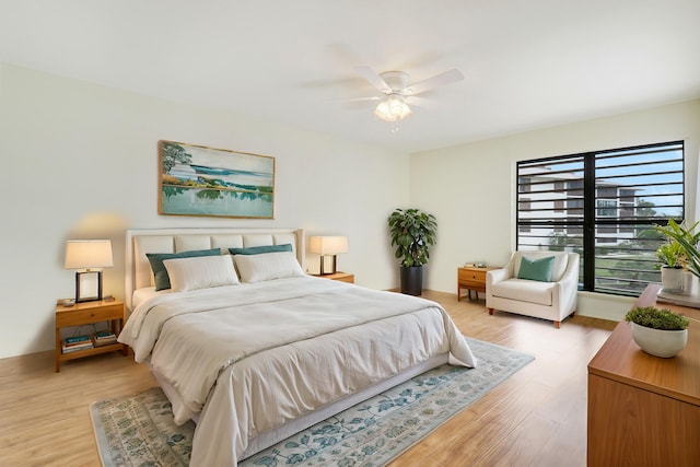 bedroom with ceiling fan and light hardwood / wood-style flooring