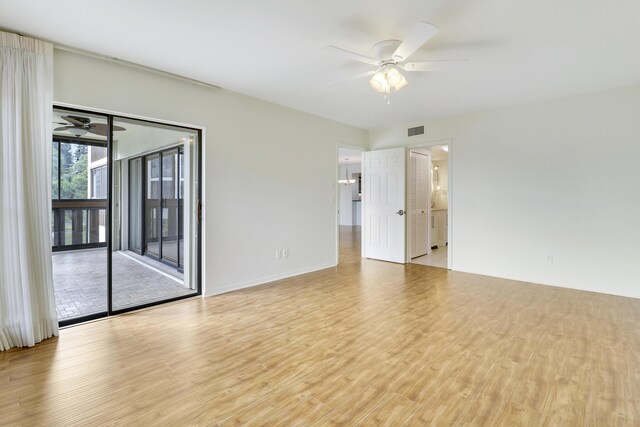 empty room featuring ceiling fan and light hardwood / wood-style flooring