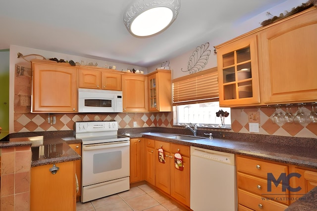 kitchen featuring light tile patterned floors, decorative backsplash, sink, and white appliances