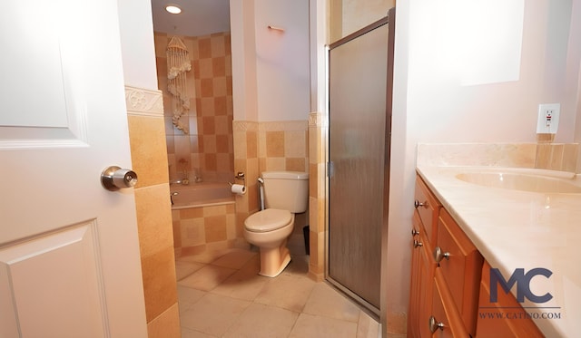 full bathroom with tile patterned floors, vanity, tile walls, toilet, and independent shower and bath