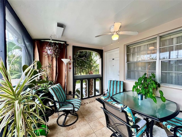 sunroom / solarium with ceiling fan and a healthy amount of sunlight